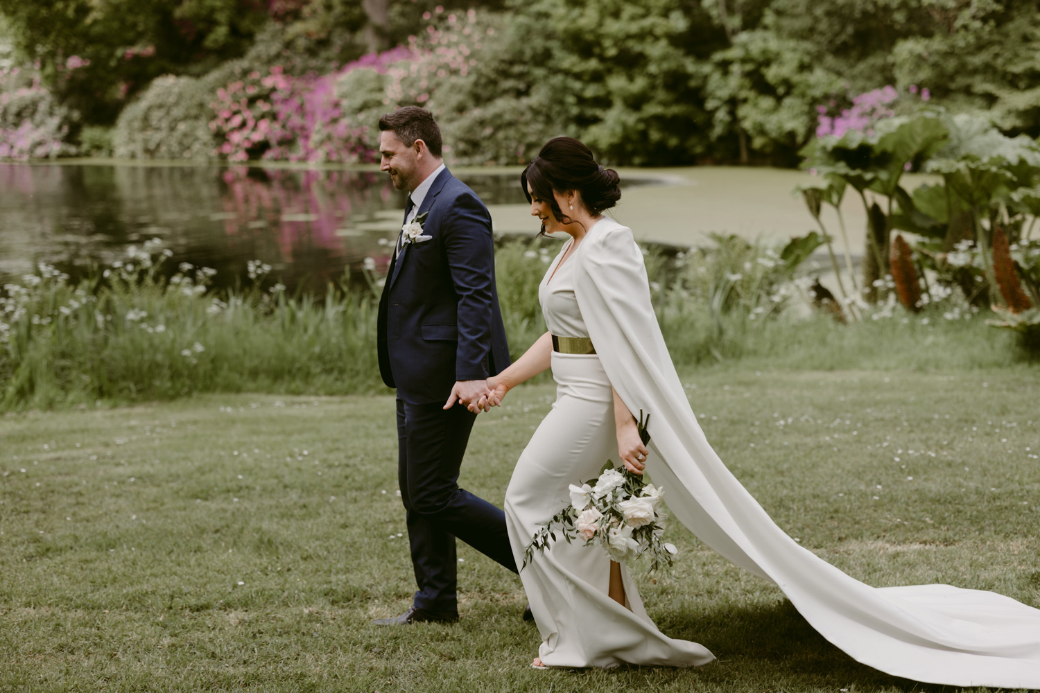 Bride and Groom walk by the Lake at Larchfield Estate Irish Wedding venue