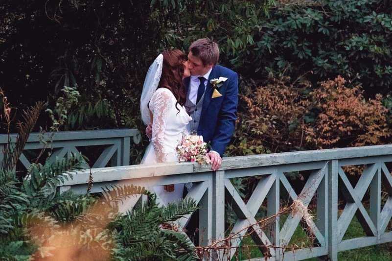 Romantic Kiss on the bridge overlooking the lake at Larchfield Estate Irish Wedding Venue