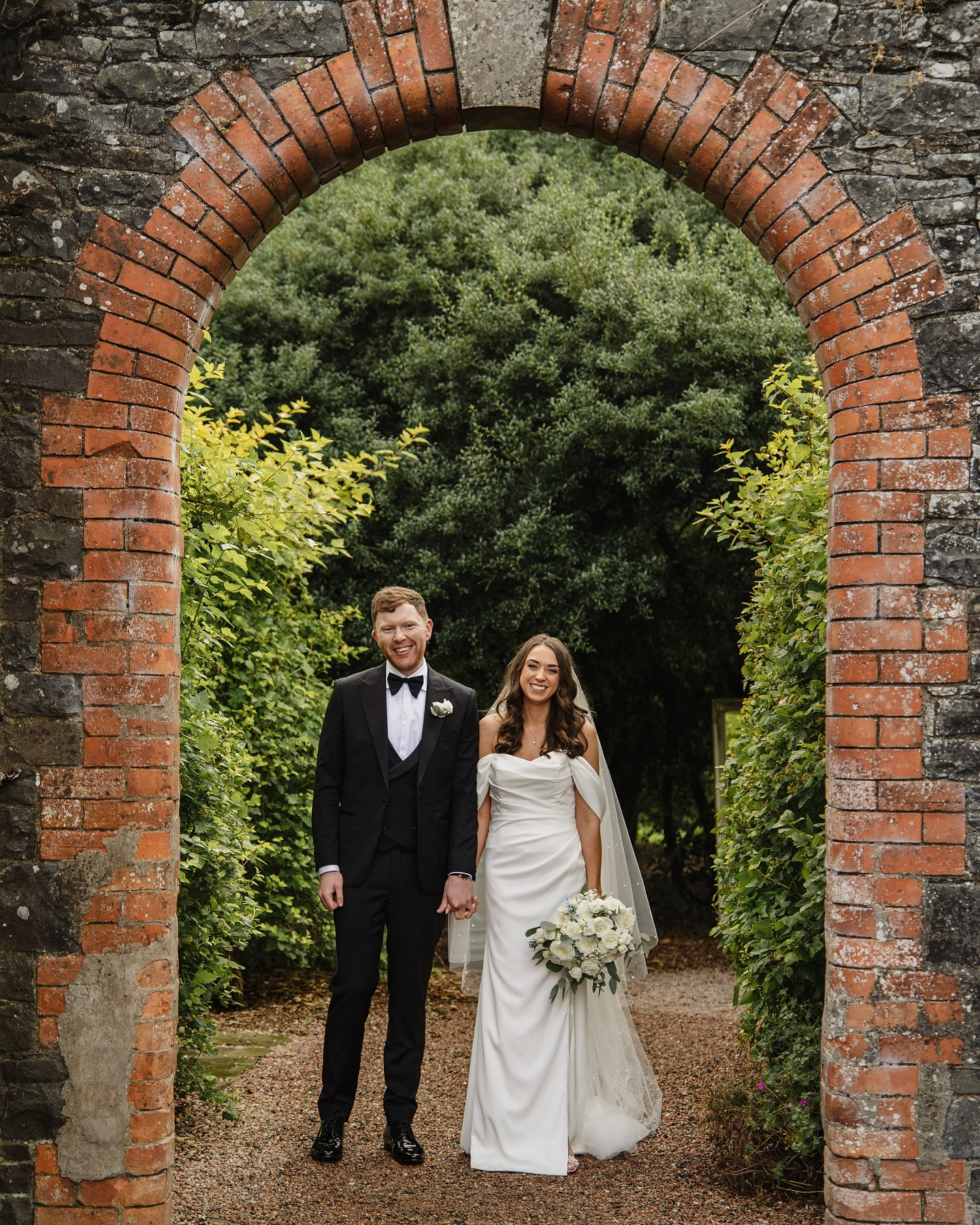Couple under the Heritage Stone Arch at Premier Irish Wedding Venue Ireland Larchfield Estate