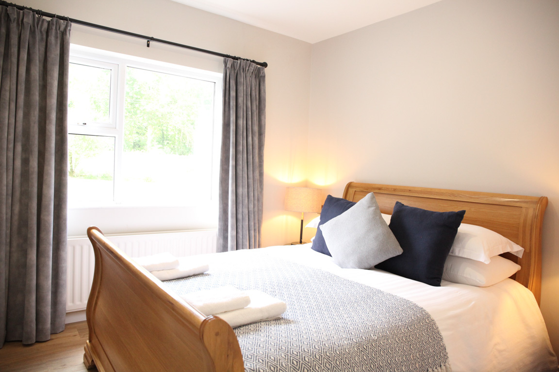 Cozy bedroom at No 23 Ideal for groups up to 11 to stay overnight with its spacious dining room, large garden and hot tub.