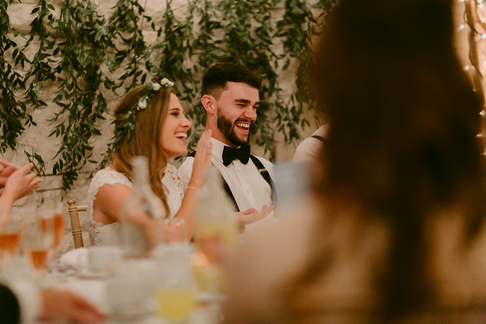 Bride and Groom listen to the speeches at their wedding in Larchfield Barn Northern Ireland best wedding venue